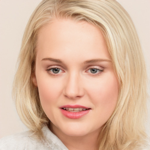 Joyful white young-adult female with long  brown hair and blue eyes