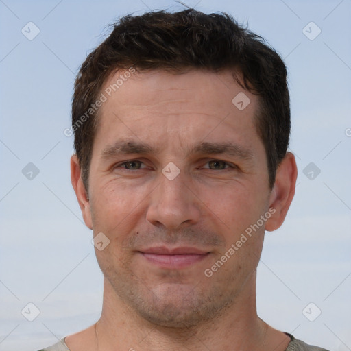 Joyful white adult male with short  brown hair and brown eyes