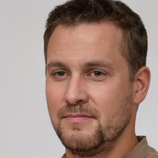 Joyful white adult male with short  brown hair and brown eyes