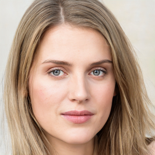 Joyful white young-adult female with long  brown hair and green eyes