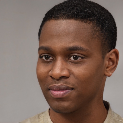 Joyful latino young-adult male with short  brown hair and brown eyes