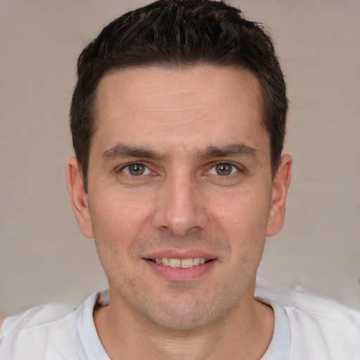 Joyful white young-adult male with short  brown hair and brown eyes