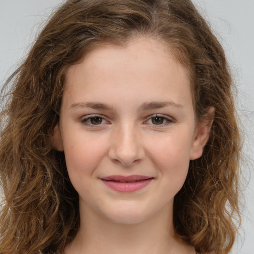 Joyful white child female with long  brown hair and brown eyes