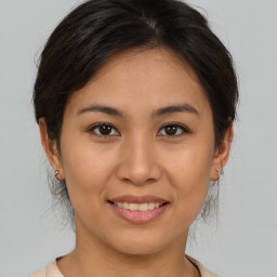 Joyful asian young-adult female with medium  brown hair and brown eyes