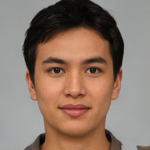 Joyful asian young-adult male with short  brown hair and brown eyes