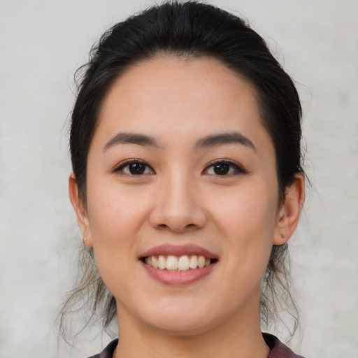 Joyful white young-adult female with medium  black hair and brown eyes