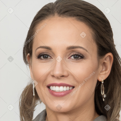 Joyful white adult female with long  brown hair and brown eyes