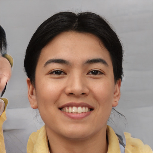 Joyful asian young-adult female with medium  brown hair and brown eyes