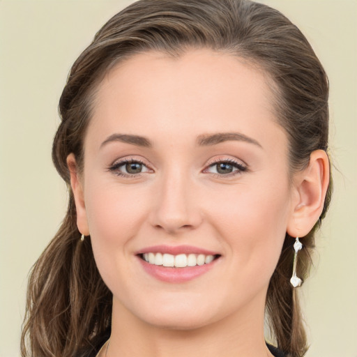 Joyful white young-adult female with long  brown hair and blue eyes