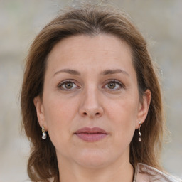 Joyful white adult female with medium  brown hair and grey eyes