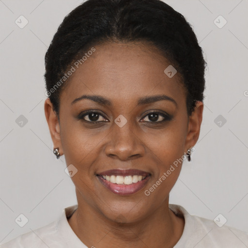 Joyful black young-adult female with short  black hair and brown eyes