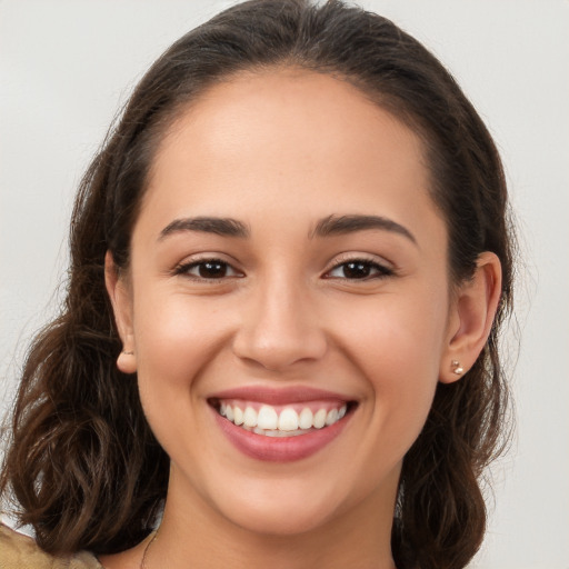 Joyful white young-adult female with long  brown hair and brown eyes