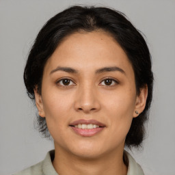 Joyful latino young-adult female with medium  brown hair and brown eyes