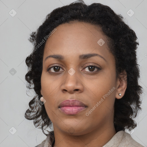 Joyful black young-adult female with long  black hair and brown eyes