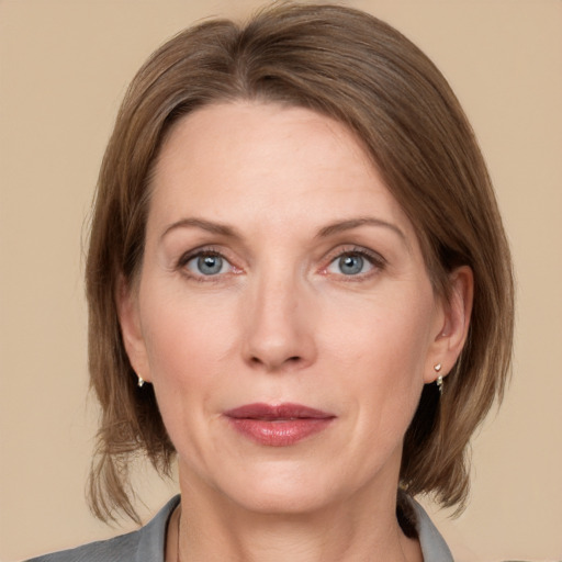 Joyful white adult female with medium  brown hair and grey eyes