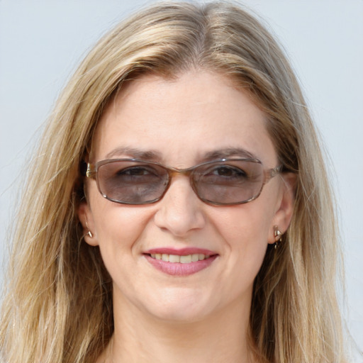 Joyful white adult female with long  brown hair and brown eyes