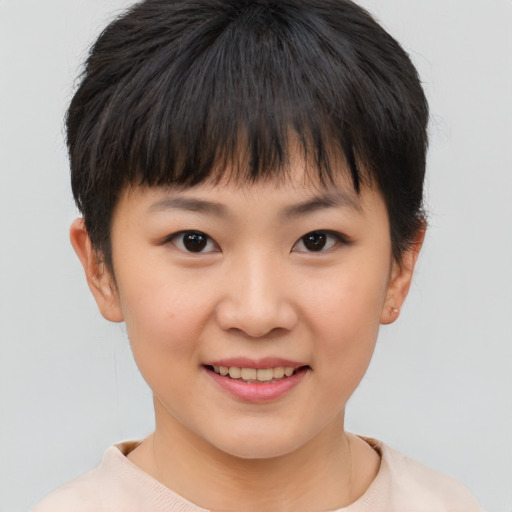 Joyful asian child female with short  brown hair and brown eyes
