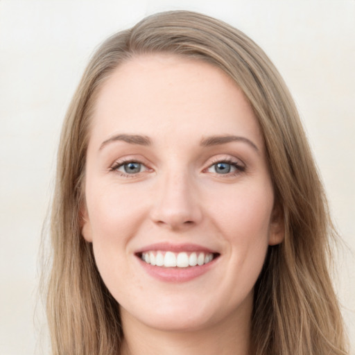 Joyful white young-adult female with long  brown hair and blue eyes