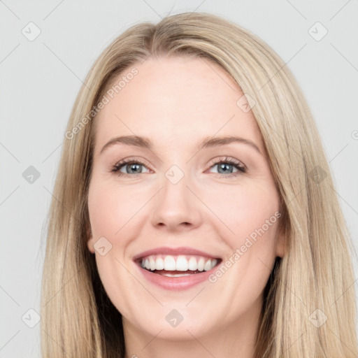 Joyful white young-adult female with long  brown hair and grey eyes