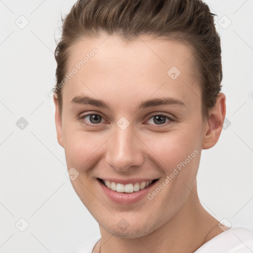 Joyful white young-adult female with short  brown hair and brown eyes