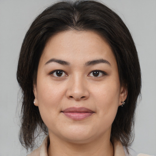 Joyful latino young-adult female with medium  brown hair and brown eyes
