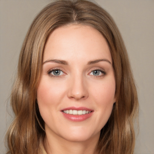 Joyful white young-adult female with medium  brown hair and green eyes