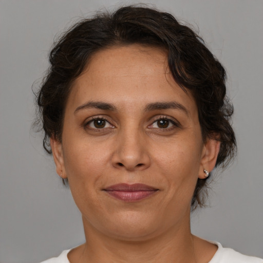 Joyful white adult female with medium  brown hair and brown eyes