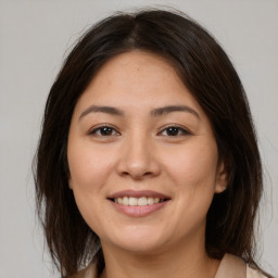 Joyful white young-adult female with medium  brown hair and brown eyes