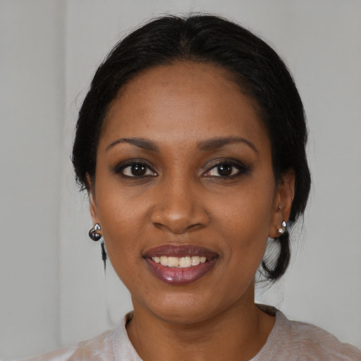 Joyful black young-adult female with medium  black hair and brown eyes