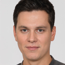 Joyful white adult male with short  brown hair and grey eyes