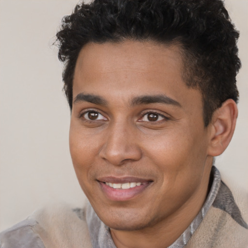 Joyful latino young-adult male with short  brown hair and brown eyes