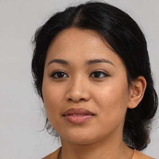 Joyful latino young-adult female with medium  black hair and brown eyes