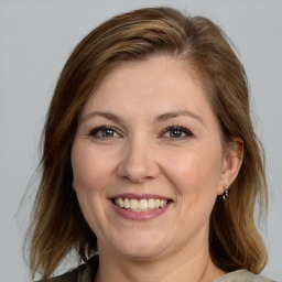 Joyful white adult female with medium  brown hair and brown eyes