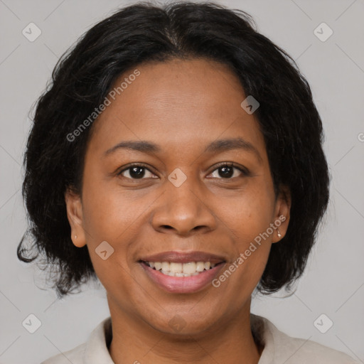 Joyful black adult female with medium  brown hair and brown eyes