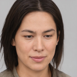 Joyful asian adult female with medium  brown hair and brown eyes