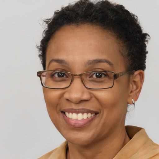 Joyful black adult female with short  brown hair and brown eyes