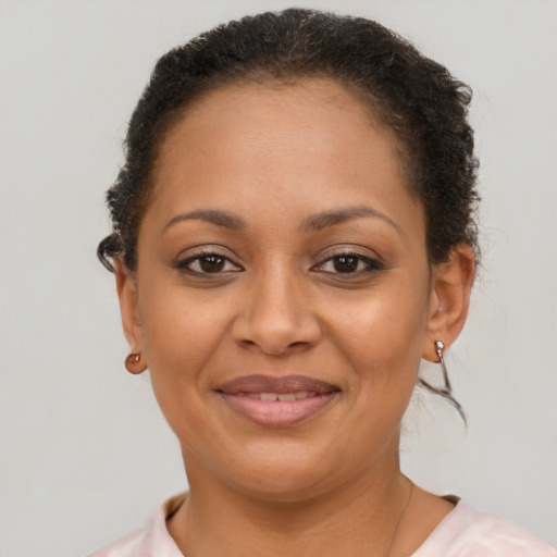 Joyful black young-adult female with short  brown hair and brown eyes