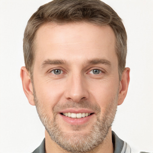 Joyful white young-adult male with short  brown hair and grey eyes