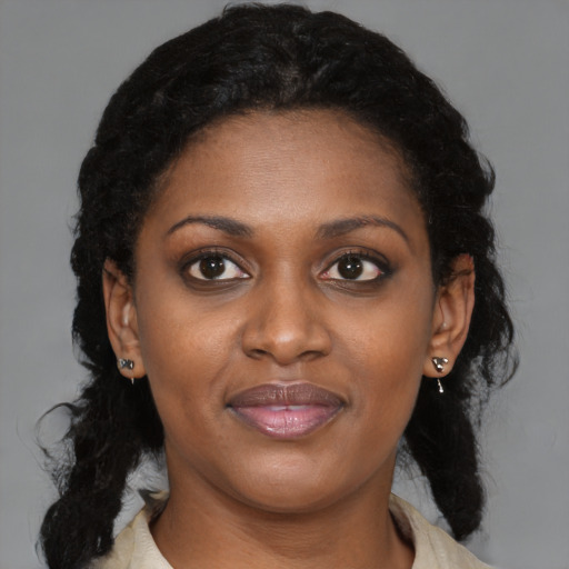 Joyful black young-adult female with medium  brown hair and brown eyes