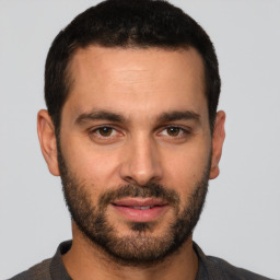 Joyful white young-adult male with short  brown hair and brown eyes