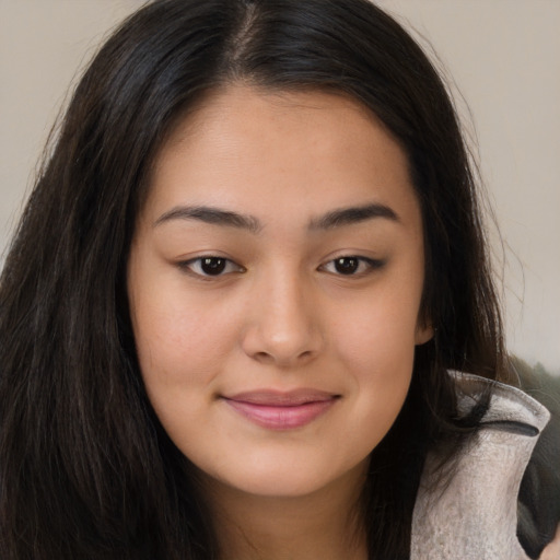 Joyful asian young-adult female with long  brown hair and brown eyes