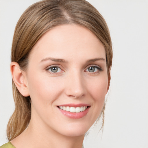 Joyful white young-adult female with medium  brown hair and green eyes