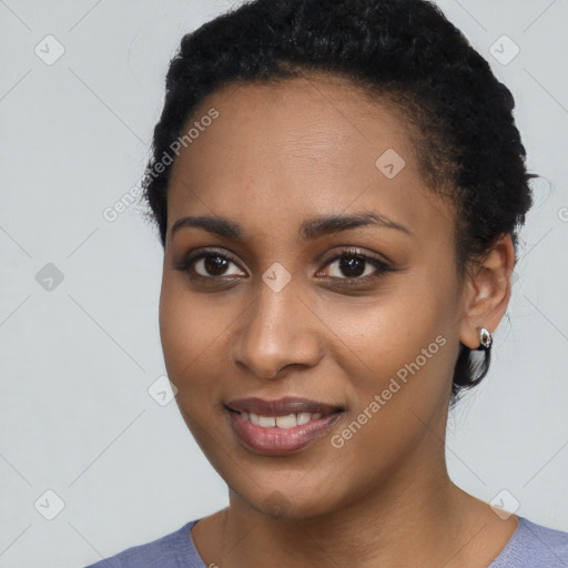 Joyful black young-adult female with short  black hair and brown eyes