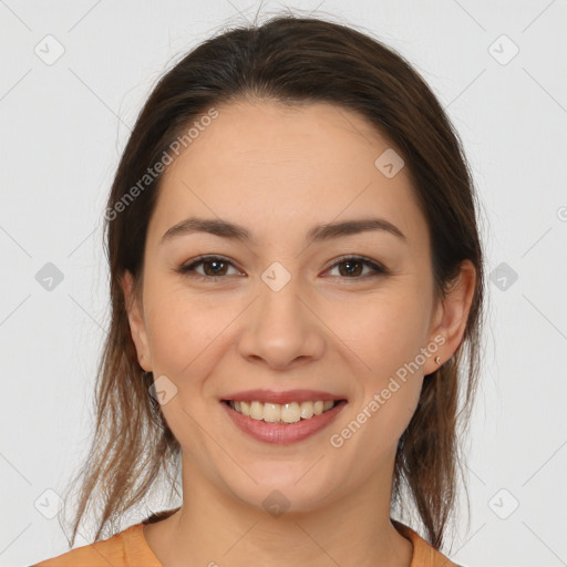 Joyful white young-adult female with long  brown hair and brown eyes