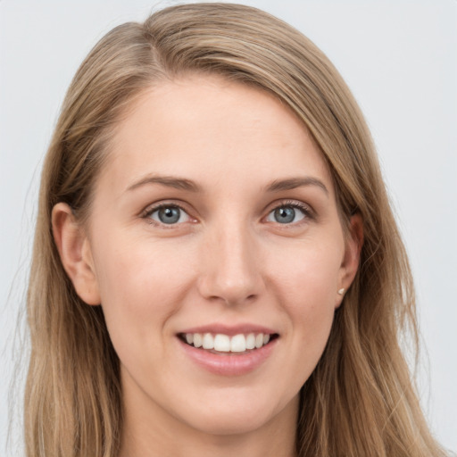 Joyful white young-adult female with long  brown hair and blue eyes