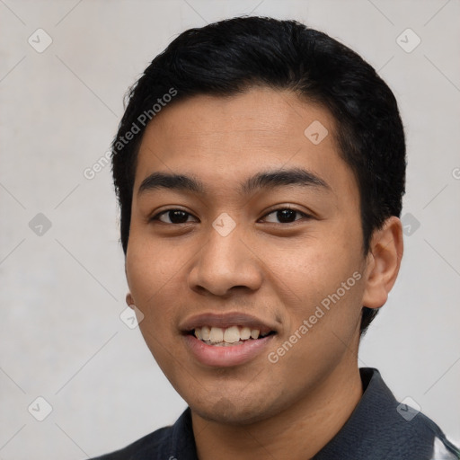 Joyful latino young-adult male with short  black hair and brown eyes