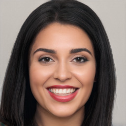 Joyful latino young-adult female with long  black hair and brown eyes