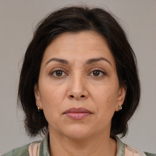 Joyful white adult female with medium  brown hair and brown eyes