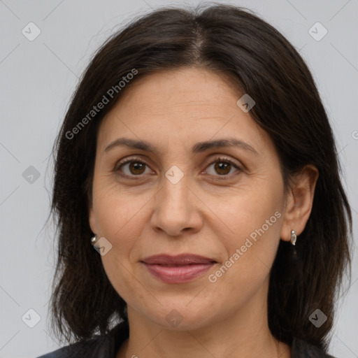 Joyful white adult female with medium  brown hair and brown eyes