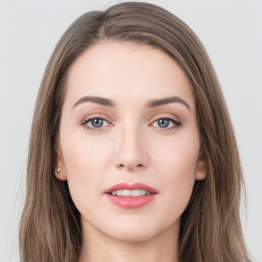 Joyful white young-adult female with long  brown hair and grey eyes